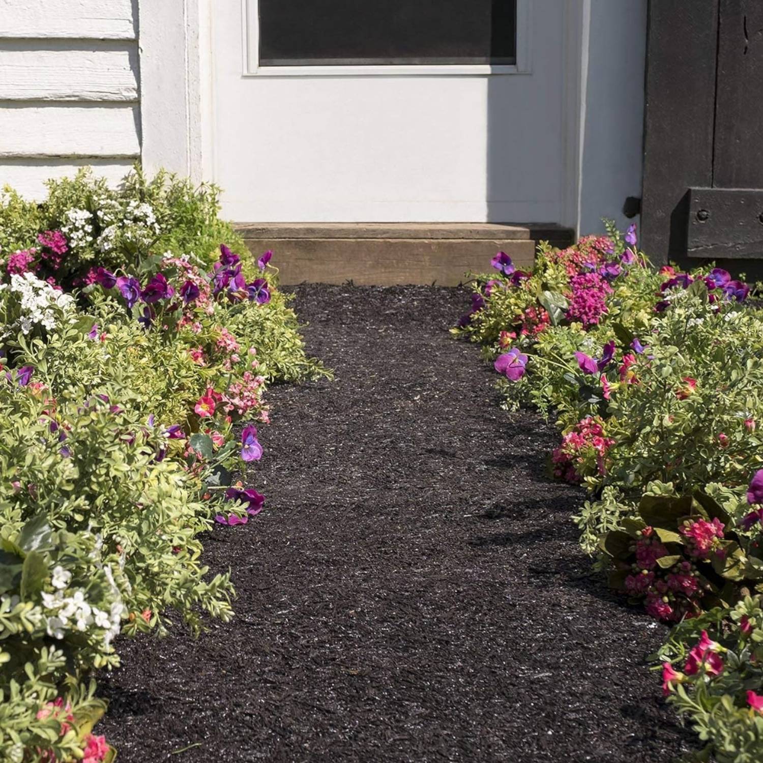 Deep profile border holding a mulch bed back from the lawn